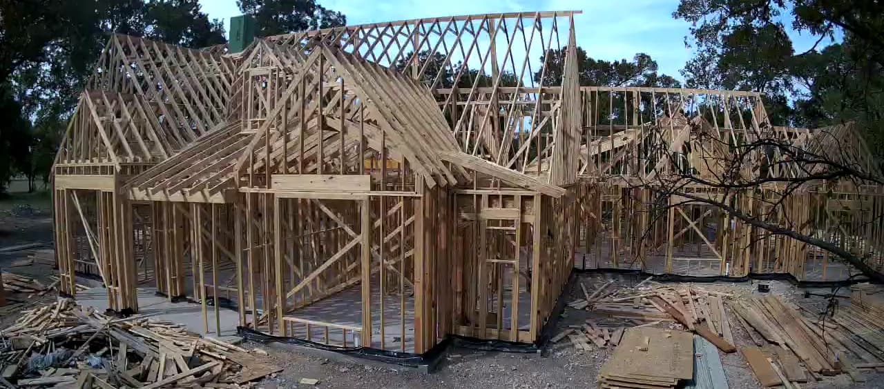 The whole timber frame from the front, roof framing over every bay.