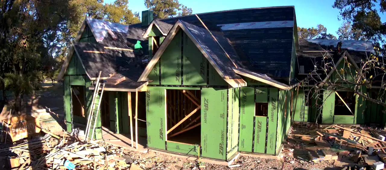The roof decked and shingled over sheathed walls.